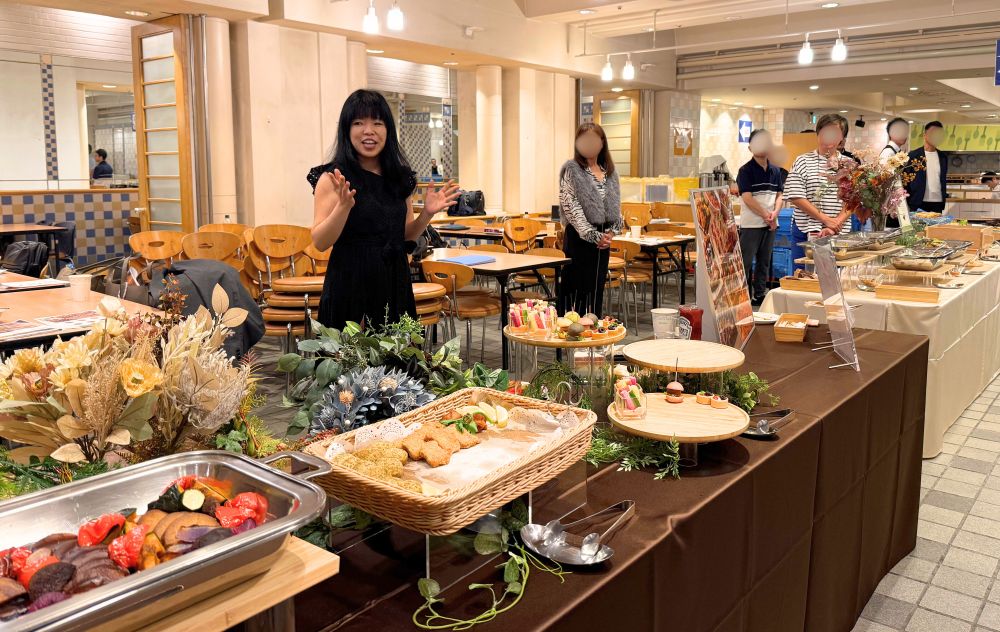 VegeProject representative Yoko Kawano speaking at the vegan catering tasting event